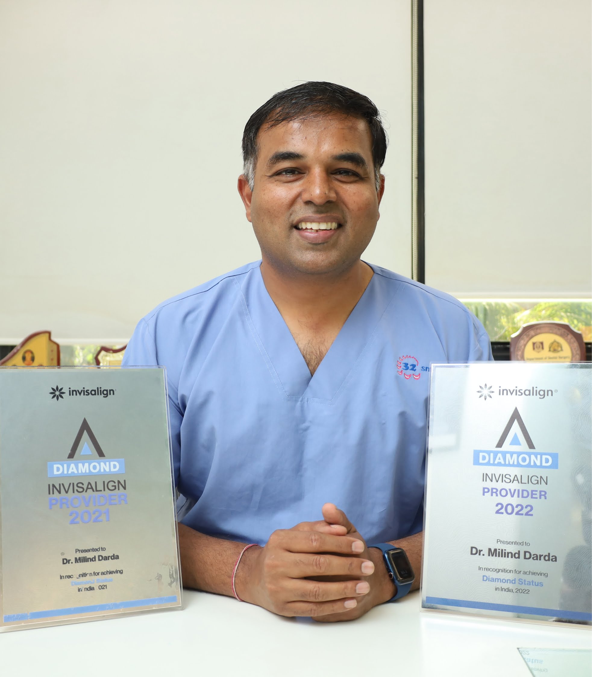 Dr. Milind Darda in 32 Smiles scrubs, smiling